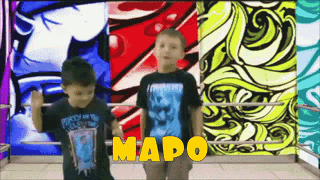 two young boys are standing in a boxing ring with the name mapo on the bottom