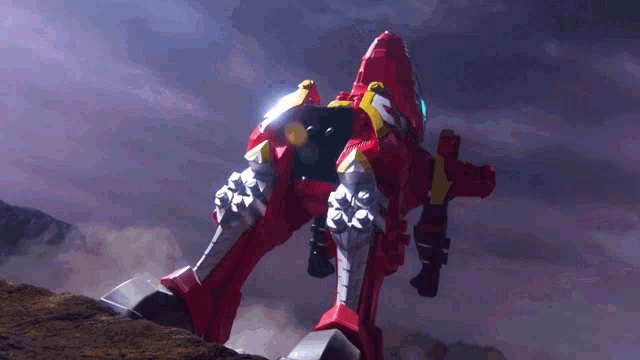 a red robot with the letter s on the back