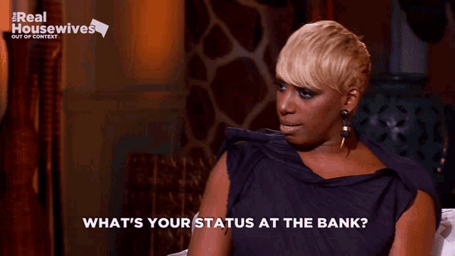 a woman is sitting on a couch with the words what 's your status at the bank