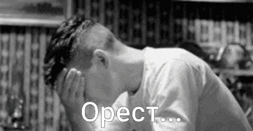 a black and white photo of a man covering his face with his hands