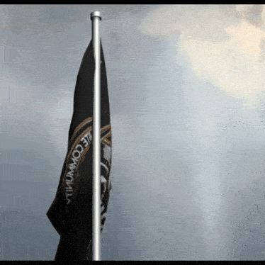 a black and white flag with the word comm on it