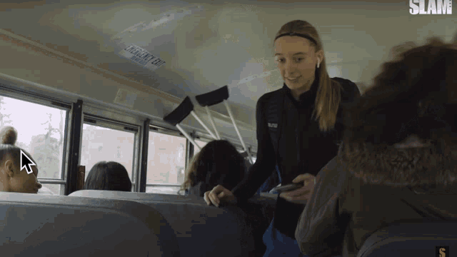 a girl on a bus with the word slam on the bottom right