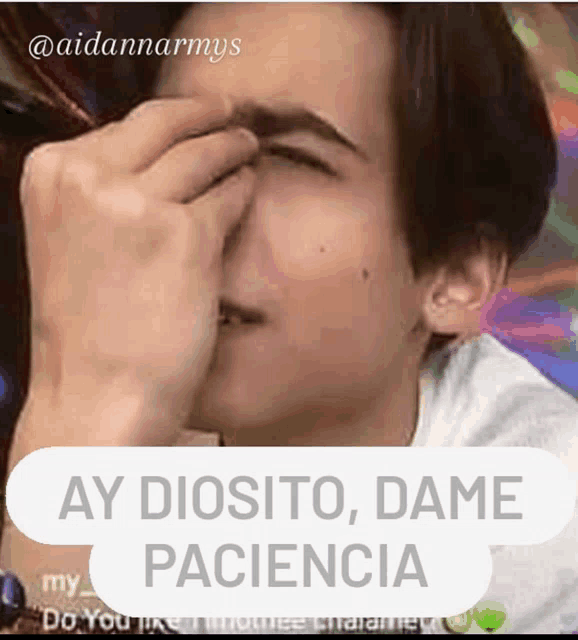 a young man covering his face with his hand and a caption that says " ay diosito dame paciencia "