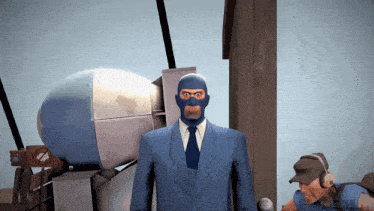 a man in a blue suit and tie is standing in front of a very large object