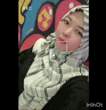 a woman wearing a hijab is being recorded in a video app