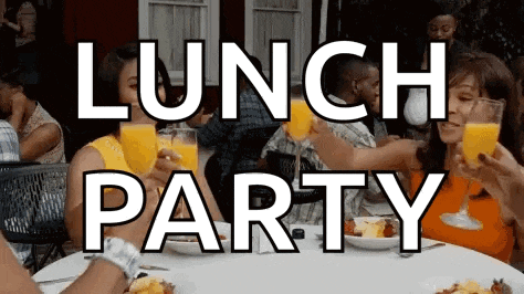 a group of people toasting with orange juice in front of a lunch party sign