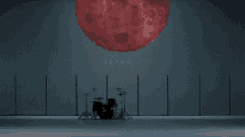 a drum set in front of a red moon with keytalk written on it