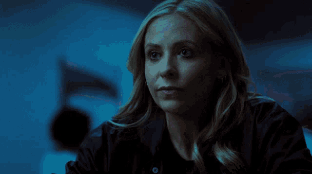 a close up of a woman 's face in the dark