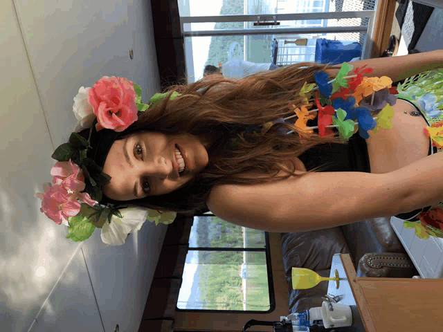 a woman wearing a flower crown and a hawaiian skirt
