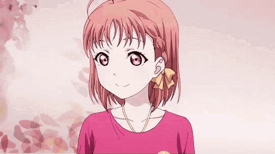 a girl with red hair is wearing a pink shirt and a yellow bow in her hair