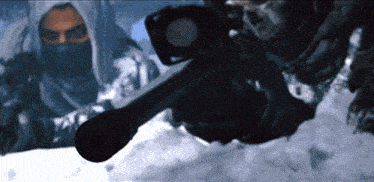 a man holding a rifle in the snow with a skull in the background