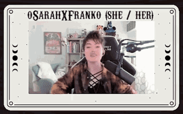 a woman is sitting in front of a microphone with the words sarahxfranko ( she / her ) written above her