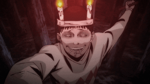 a man wearing a hat with candles on top of it