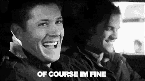 a black and white photo of two men laughing in a car and the words `` of course im fine '' .