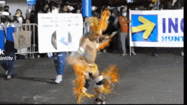a man is dancing in front of a banner that says in hunt