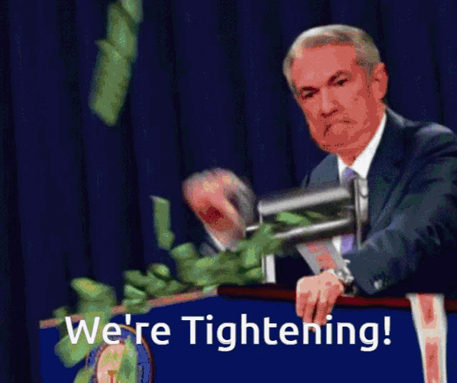 a man stands at a podium with the words we 're tightening