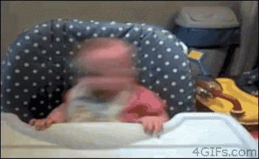 a baby is laying on a polka dot pillow on a tray .