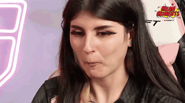 a woman is making a funny face in front of a sign that says ft on it