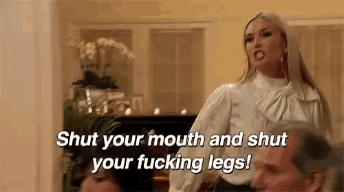 a woman is yelling at a man in a living room and says `` shut your mouth and shut your fucking legs '' .