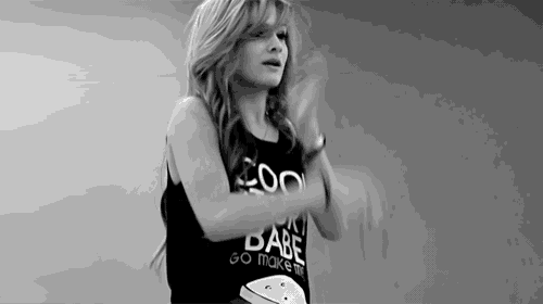 a black and white photo of a woman wearing a shirt that says go make the