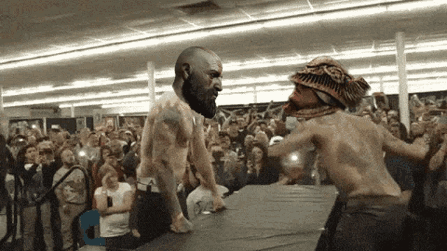 a man with a beard is standing next to a man with a hat