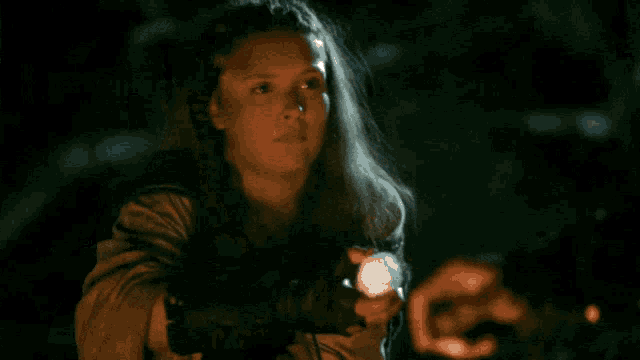a girl says " not exactly " while holding a torch
