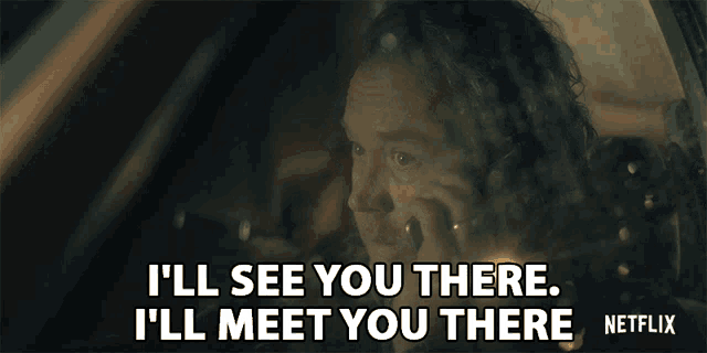 a man in a car is talking on a cell phone and says i 'll see you there