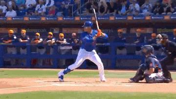 a baseball player is swinging his bat at a ball while a catcher watches .