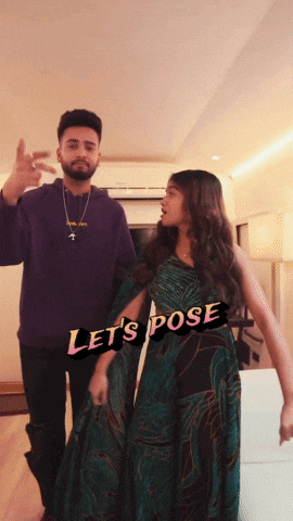 a man in a purple hoodie stands next to a woman in a green dress with the words let 's pose on the bottom