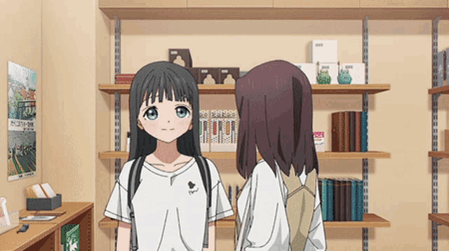 two anime girls standing next to each other in front of shelves with a poster on the wall that says ' tokyo '