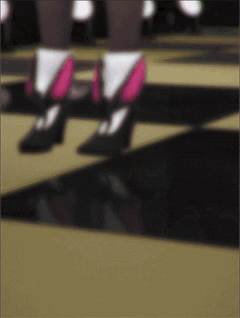 a blurry picture of a person 's feet walking on a checkerboard floor