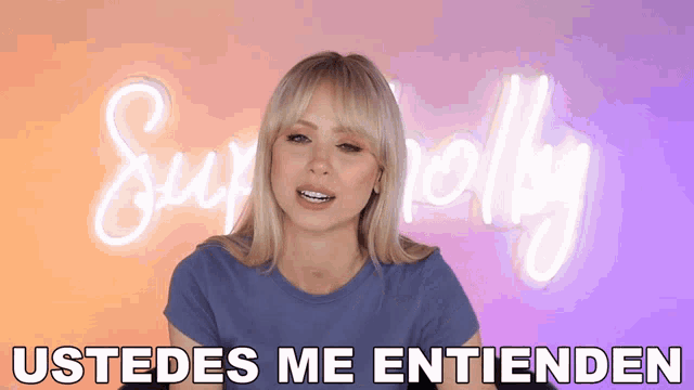 a woman says ustedes me entienden in front of a neon sign that says sympathy