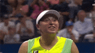 a woman wearing a yellow and green shirt with a c on it