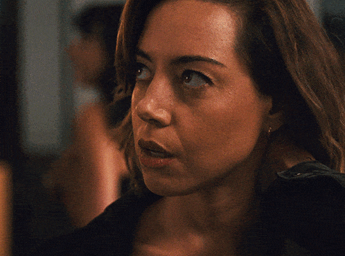 a close up of a woman 's face with a black shirt on