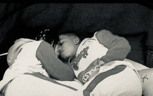 a boy wearing a shirt that says ' kings ' on it