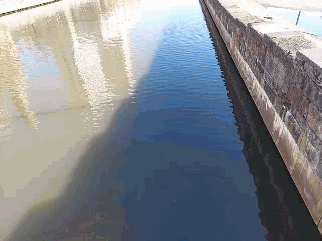 a brick wall along a body of water