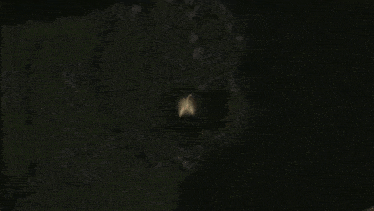 a person is standing in a dark cave with a light coming out of them