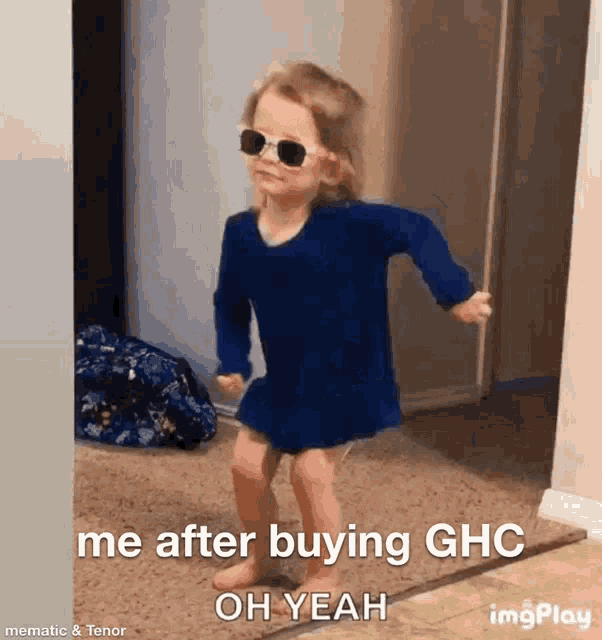 a little girl is wearing sunglasses and dancing in a hallway .
