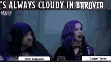 a man and a woman are sitting next to each other in a dark room with purple hair .