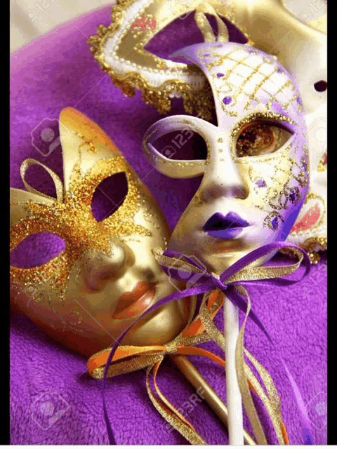 a gold and purple carnival mask on a purple background