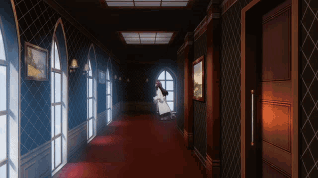 a woman in a white coat walks down a long hallway
