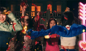 a group of women are dancing in front of a neon sign that says ' arrow ' on it .