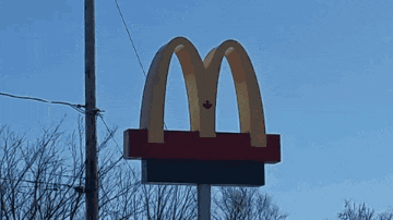 a mcdonald 's drive thru has cars lined up outside
