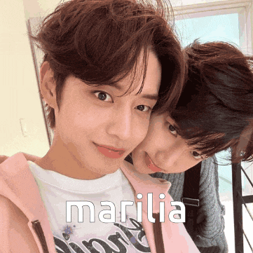a couple of people standing next to each other with marilia written on the bottom right