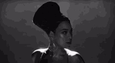 a black and white photo of a woman with a bun in her hair