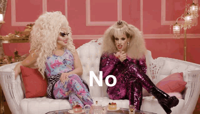 two drag queens sitting on a white couch with the word no written on the bottom
