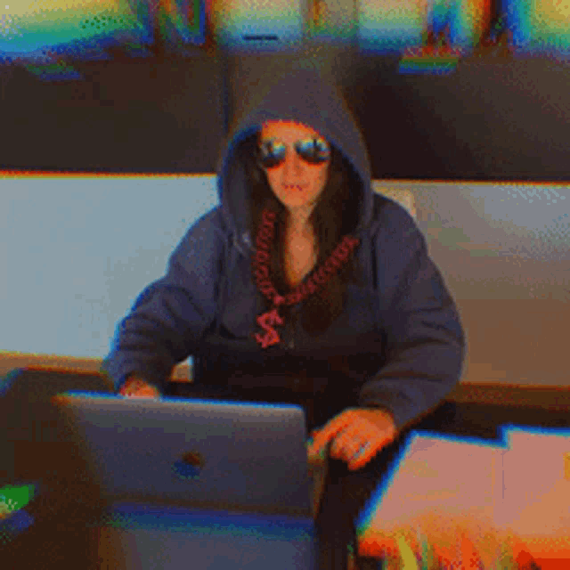 a woman wearing a hoodie and sunglasses is holding a knife and the words deal with it above her