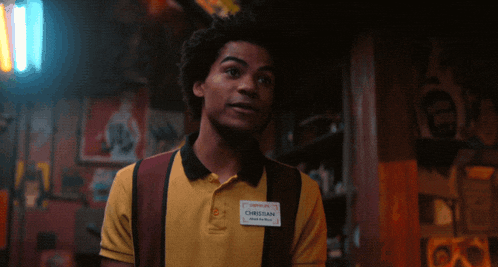 a man wearing a yellow shirt with a name tag that says christian
