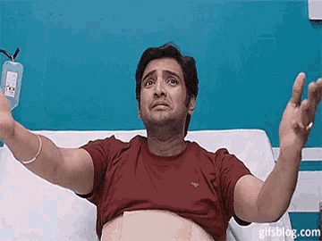 a man is in a hospital bed with his arms outstretched