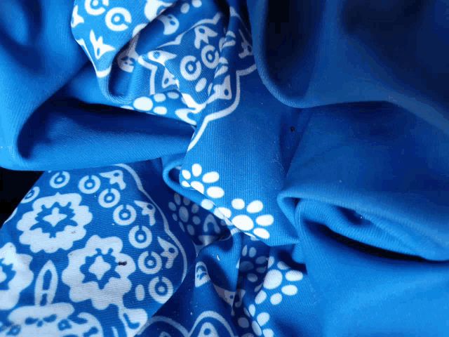 a blue bandana with white flowers and circles